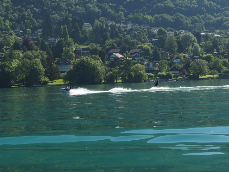 two people are in the water on a motor boat