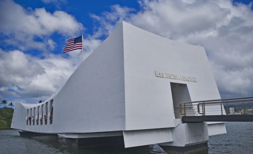 an american flag flying on the top of the uss