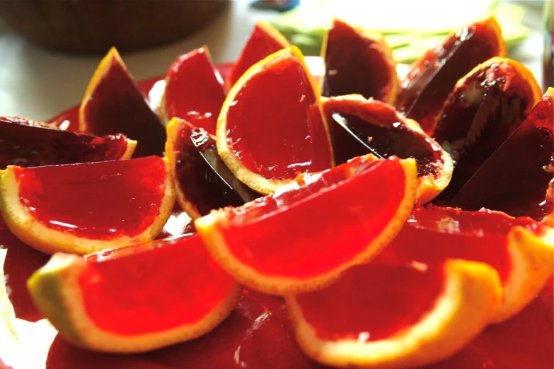 a bowl filled with red  oranges that are sliced in half