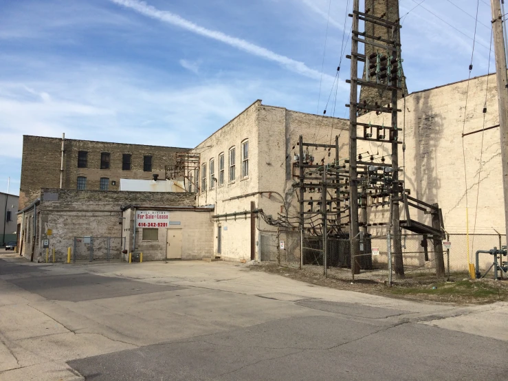 the building has a tall, industrial clock tower behind it