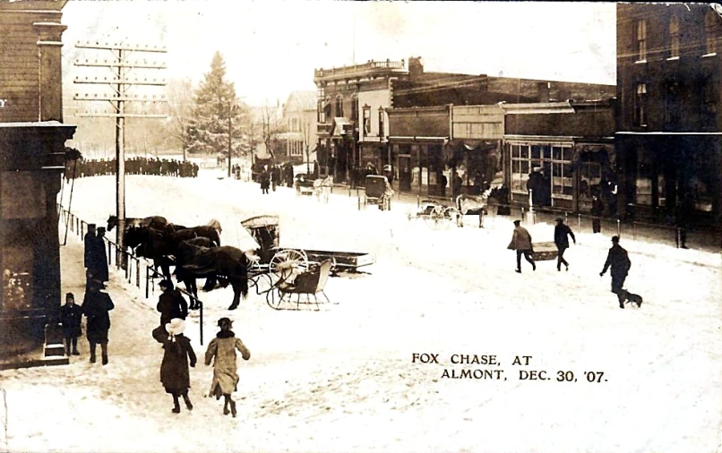 a group of people standing around horse drawn carriages