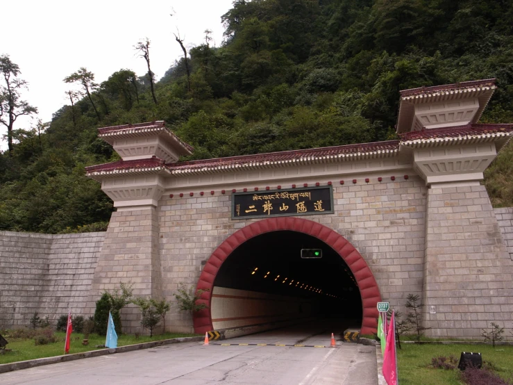 a bridge with a cave in it in the mountains