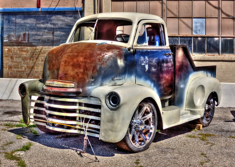 a very old truck that has a rusted out hood