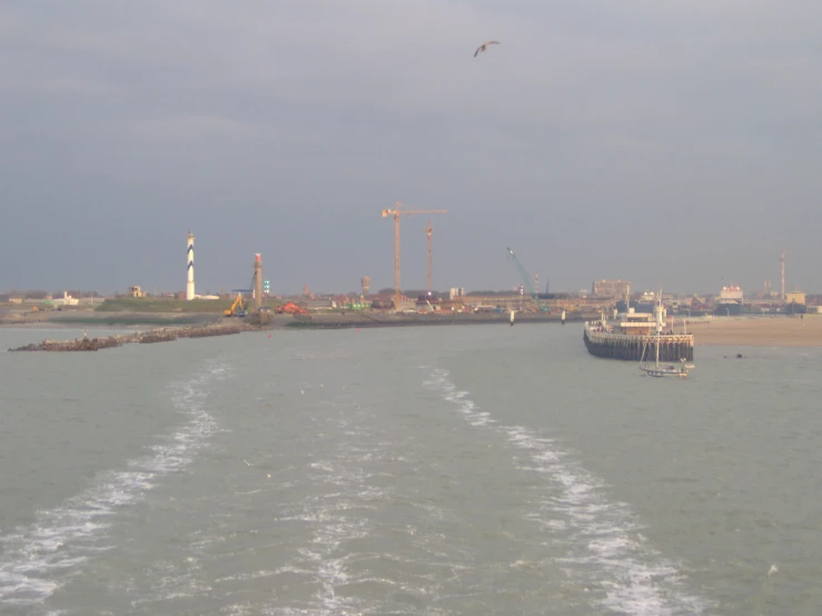 large boats are going out to sea at a boat ramp