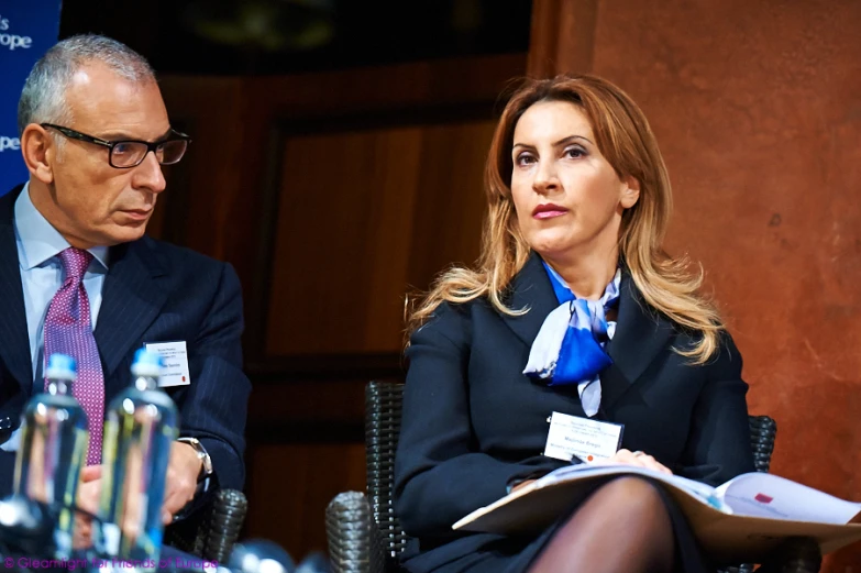 a woman and man are sitting at a table