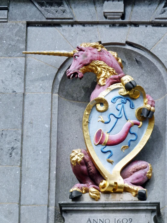 an ornate gold and blue clock on the side of a building