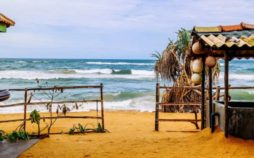 an outdoor spa is on the beach by the water