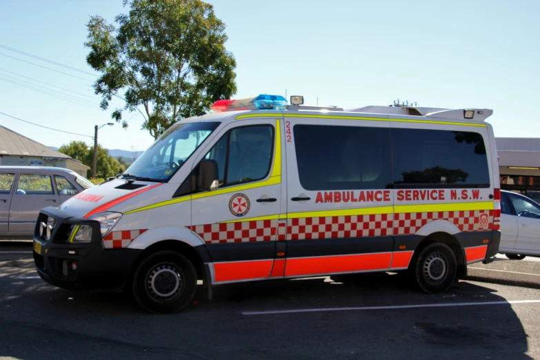 an ambulance sitting in the middle of a parking lot