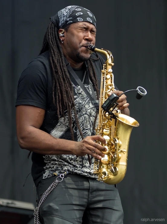 the man in dreads playing his saxophone