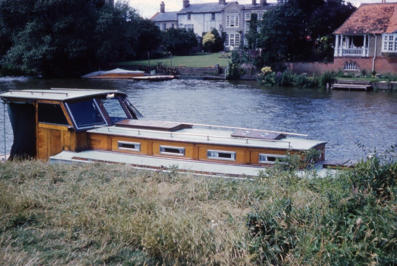 a house boat that is sitting on the water