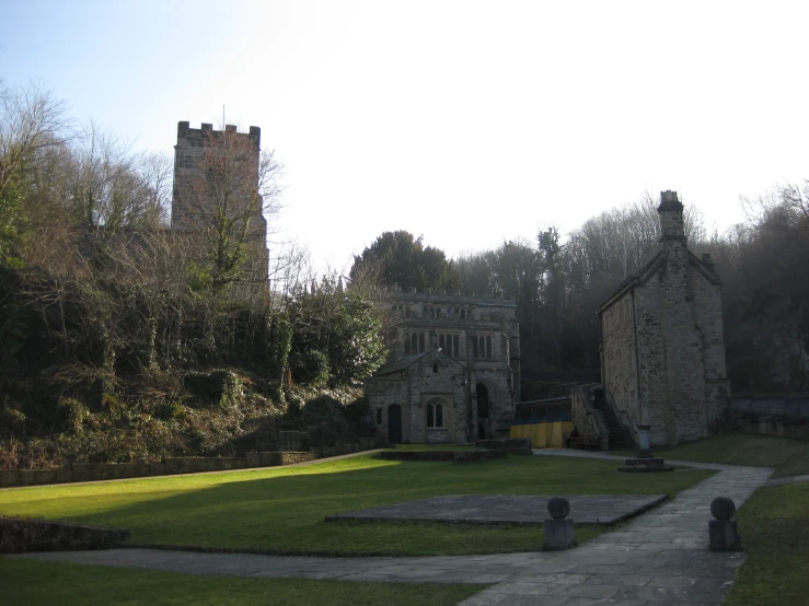 an old stone building is near an empty courtyard