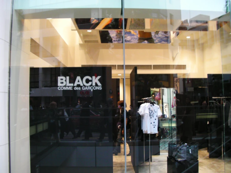 an inside view of a store window showing people in the doorway