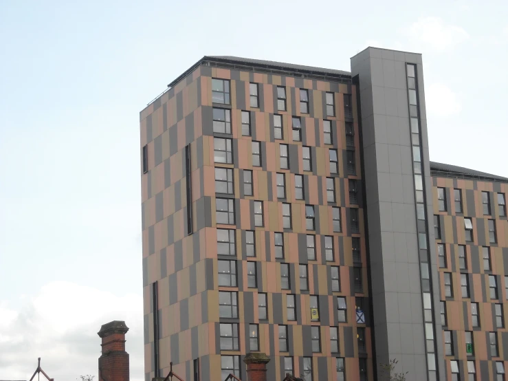 the building with its windows opened and several chimneys