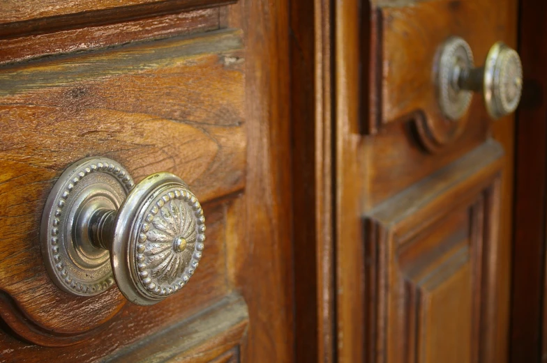 a wooden cabinet with two s and metal handles