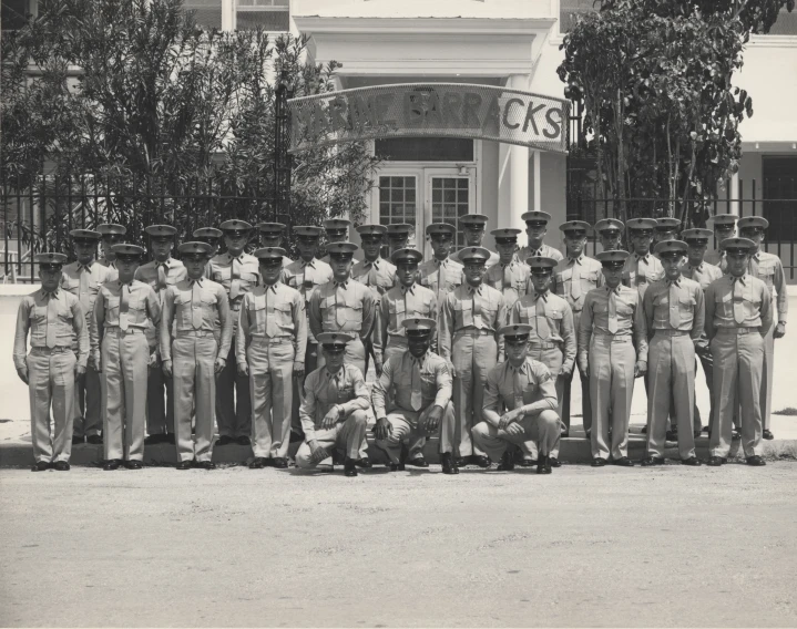 black and white po of group of uniformed soldiers in front of an entrance