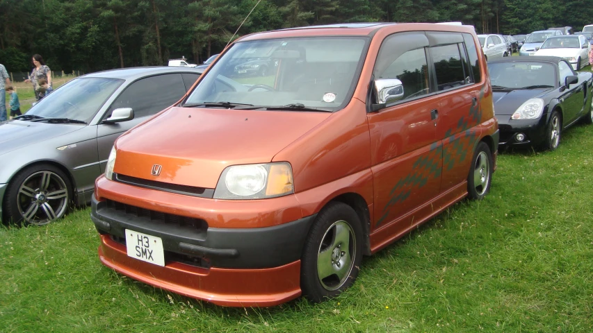 a red van parked next to other vehicles