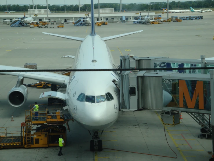 an airplane is parked at a gate near the loading dock