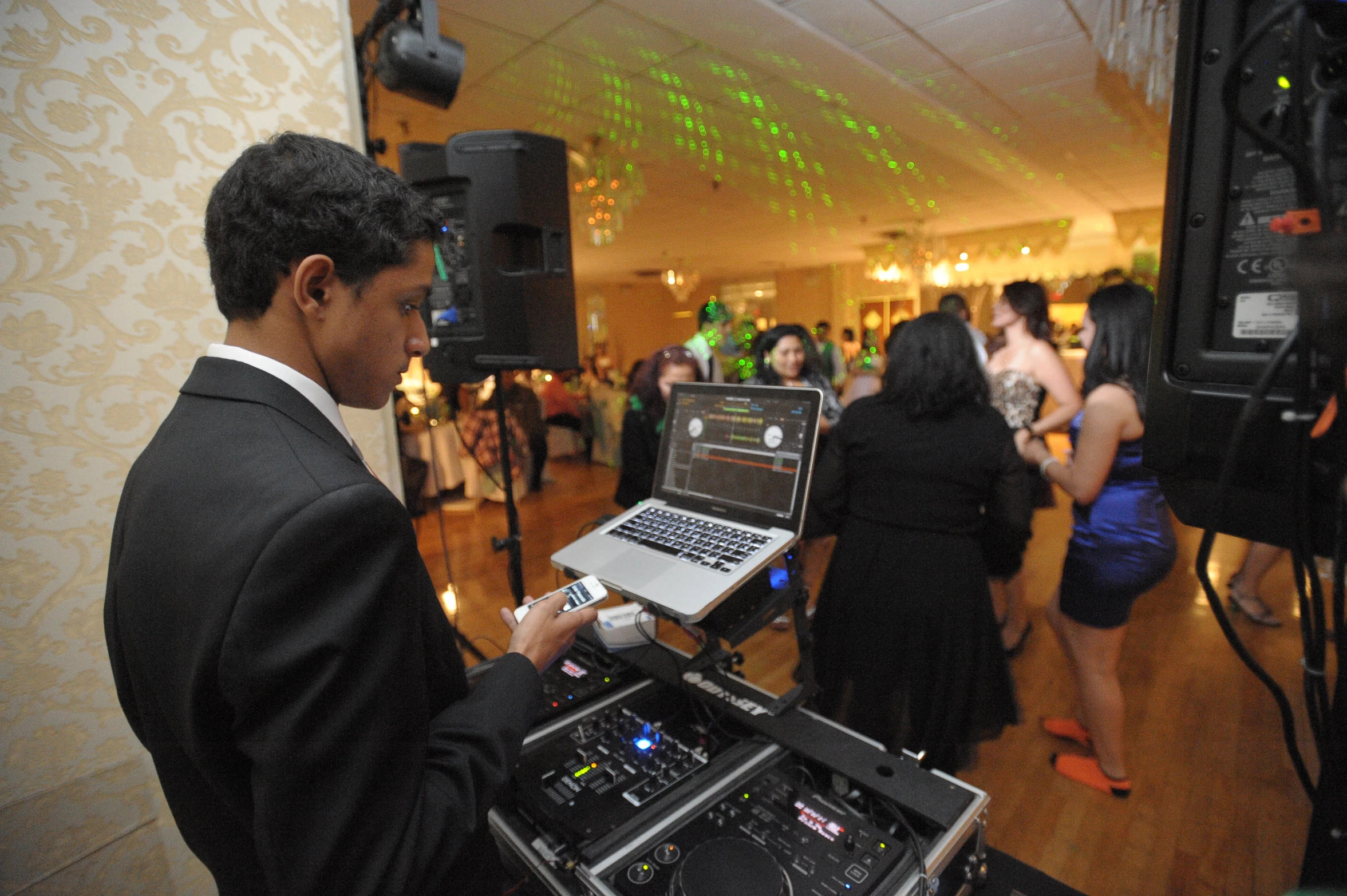 a dj is at a party and performs on the dance floor
