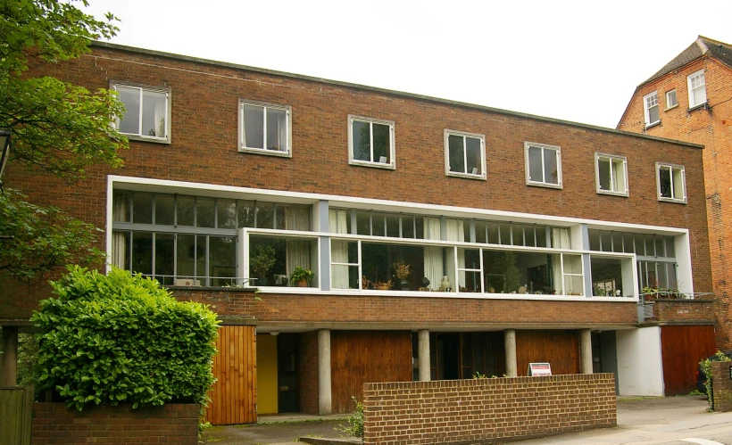 a brick building with three levels filled with windows