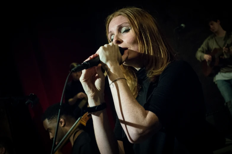 a woman that is singing into a microphone