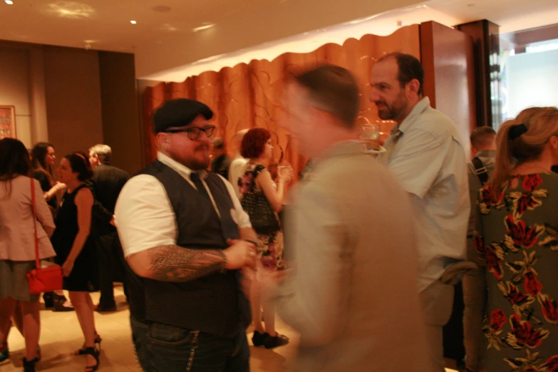 two men stand at the entrance of a party