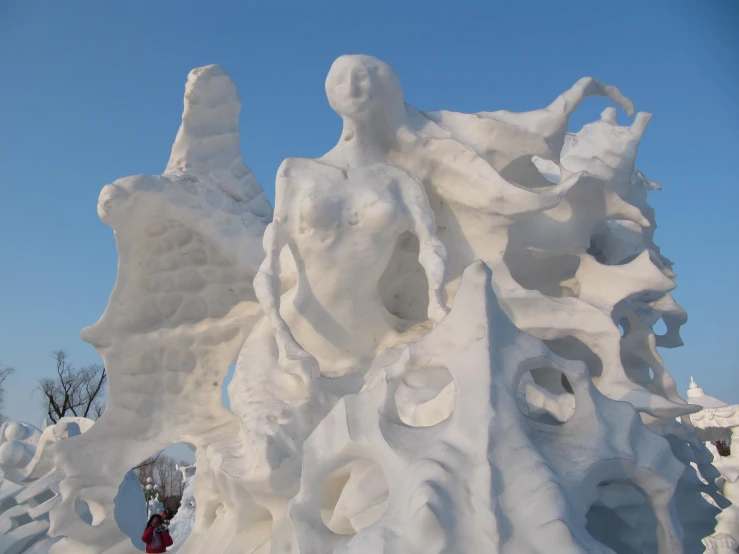people stand in front of some snowy sculptures