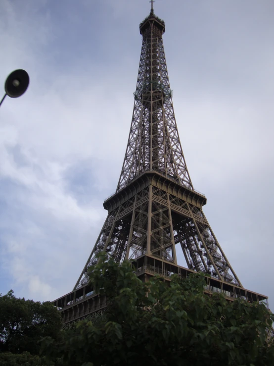 a small tower sitting under a cloudy blue sky