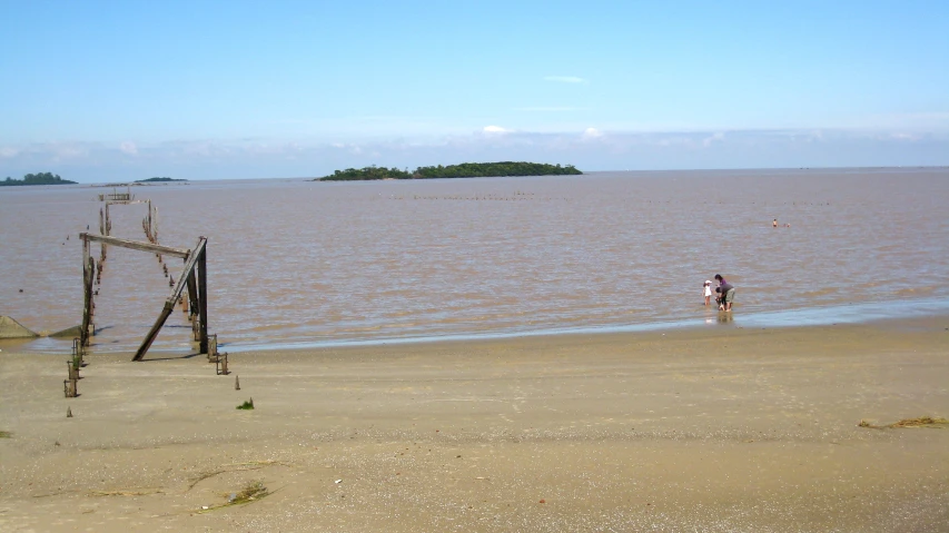 a view of the ocean with an easel and a person walking on it