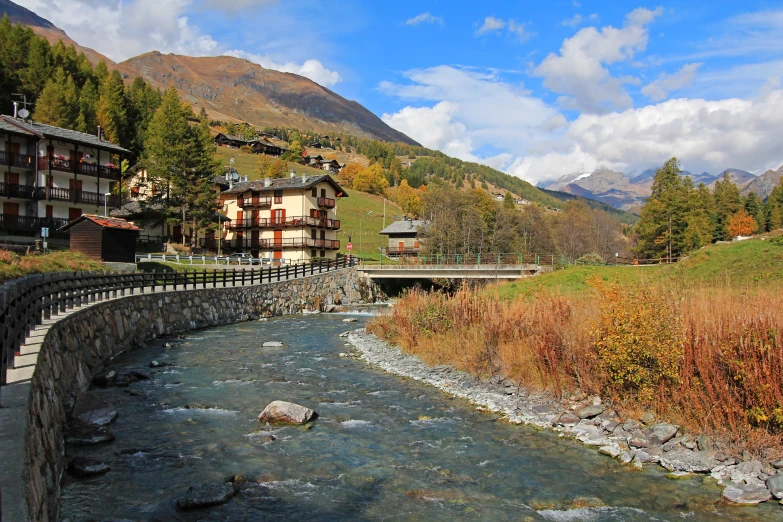 a river flows through a lush green valley