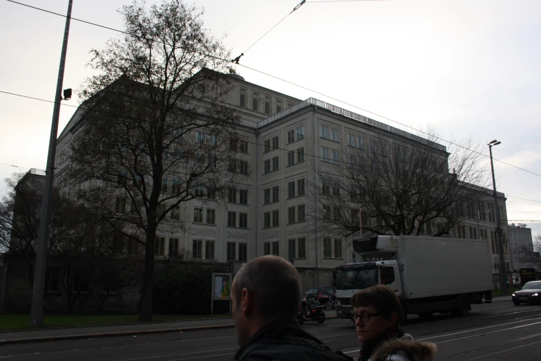 a large building with many windows and a crane over it