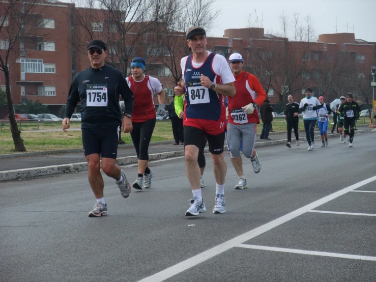 a group of people running down a street