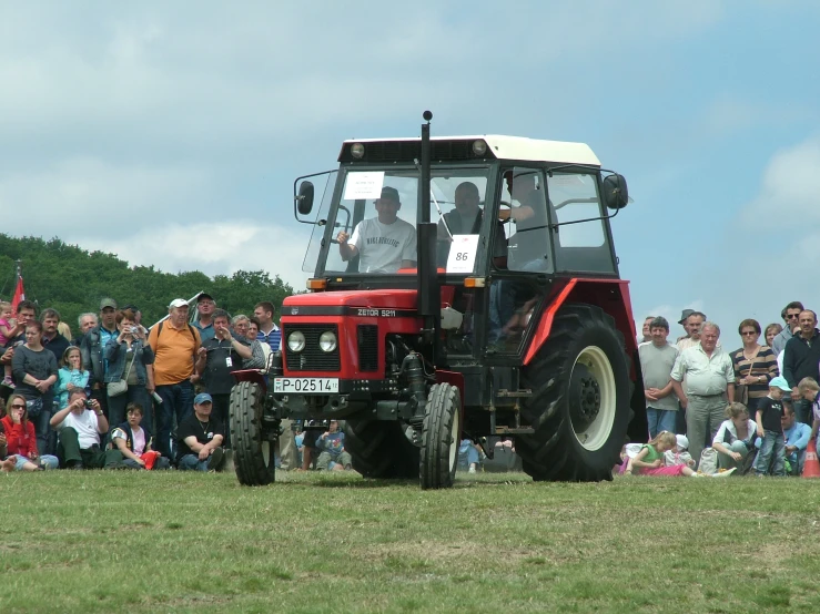 a tractor is seen during a game with spectators