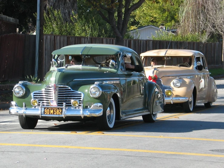 old fashion vehicles parked on a city street