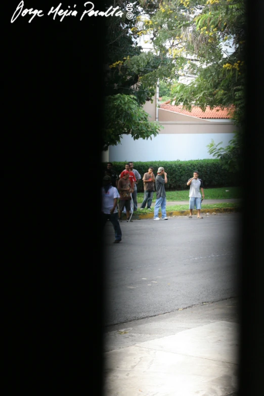 five men walking down the street in a line