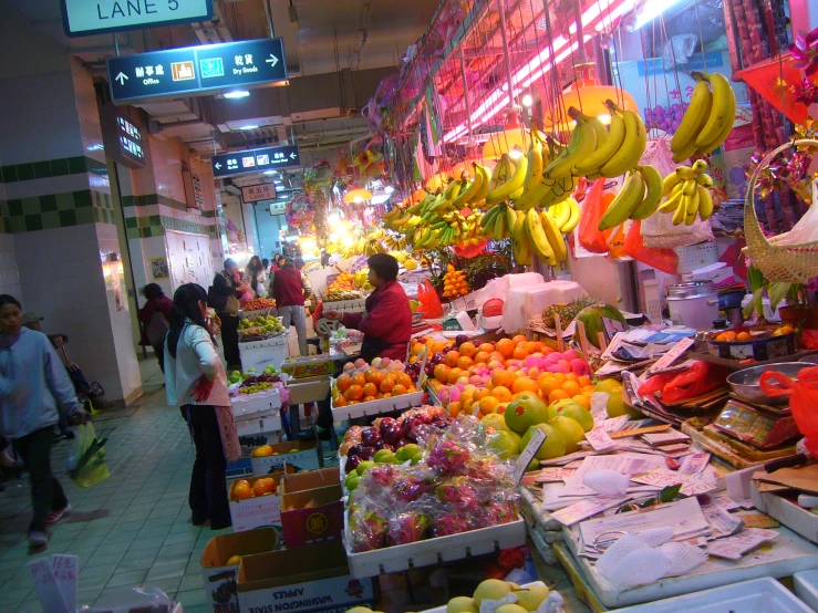 a marketplace with fruits and vegetables for sale