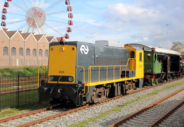 the locomotive is pulling the carts through the park