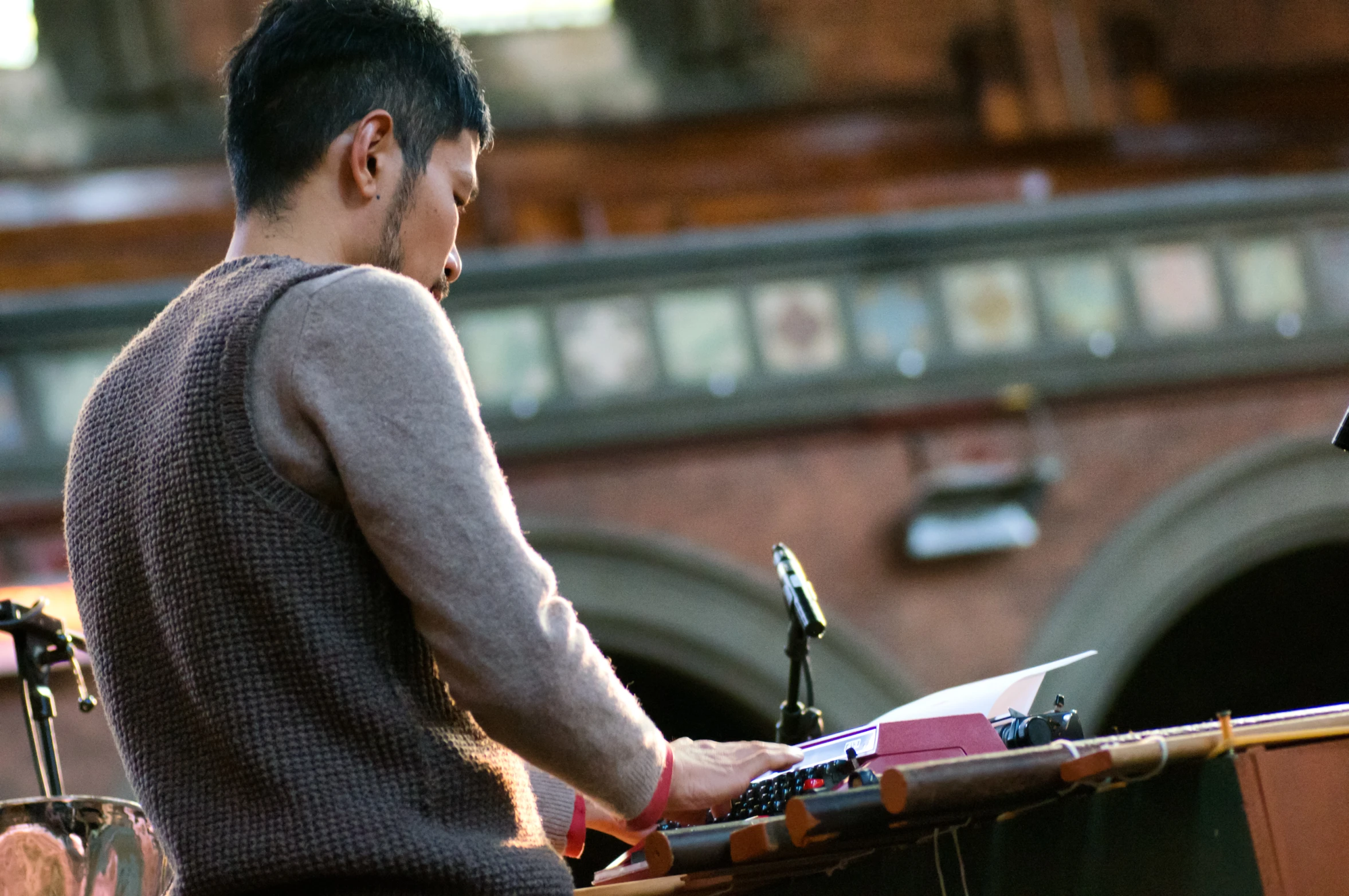 a man standing at a podium while writing