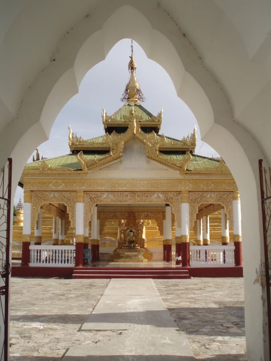 an elaborate archway has a statue in the center