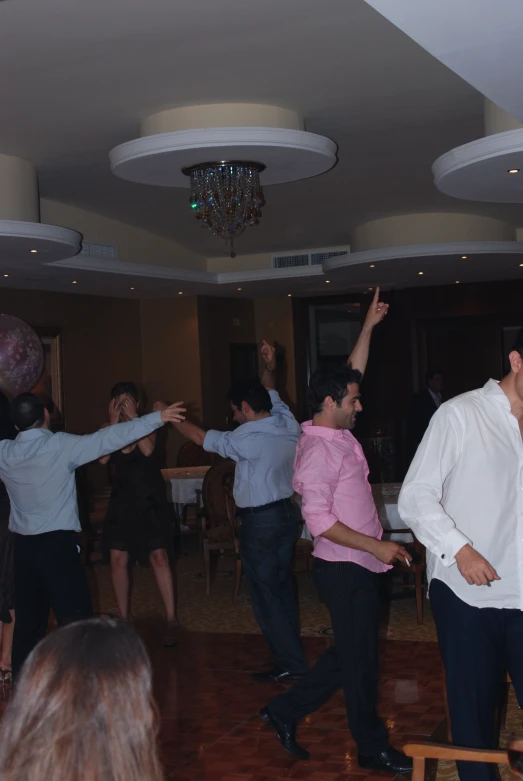 several people who are doing different dances in a room