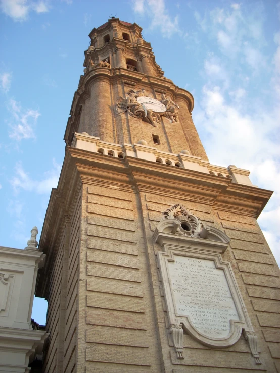 a tall clock tower with carvings on top