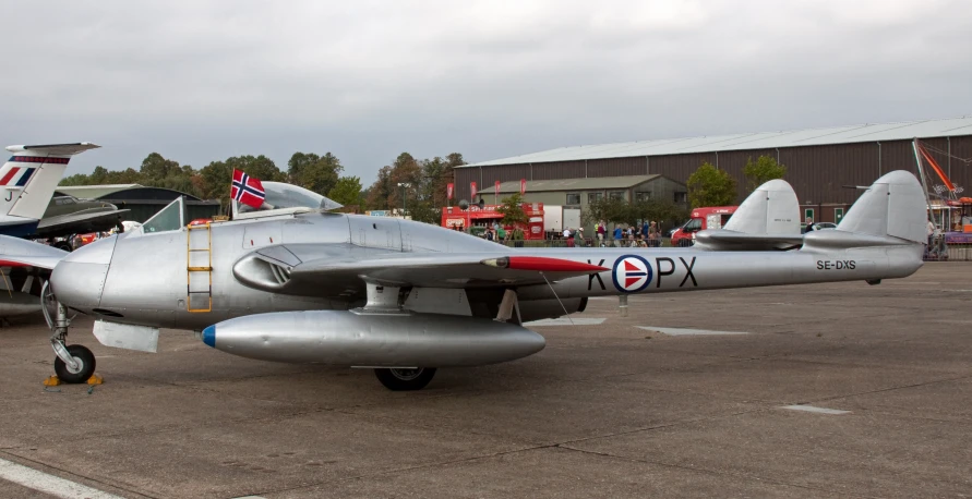 a pair of fighter jets sitting in an airport lot