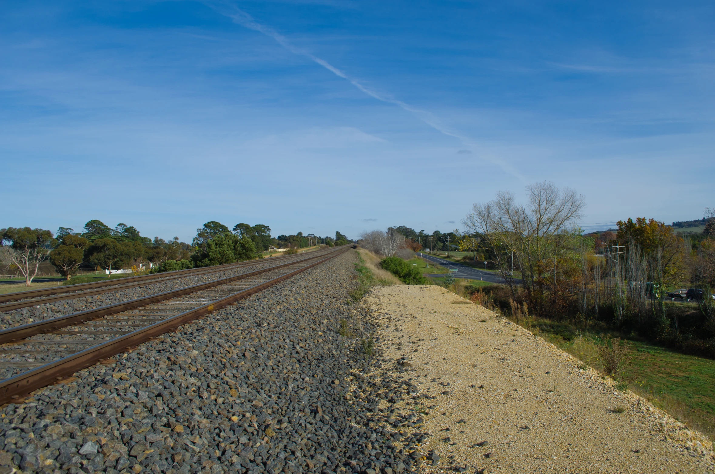 the sky is very bright and there are two tracks going