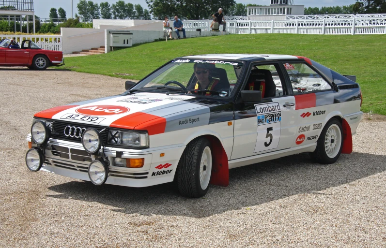 an automobile with wheels that are white and red