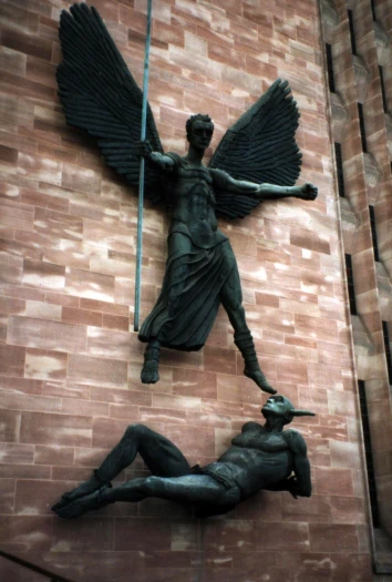 sculpture depicting man being attacked by an angel