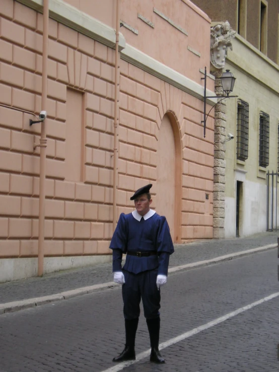 a man wearing a black hat and blue clothing