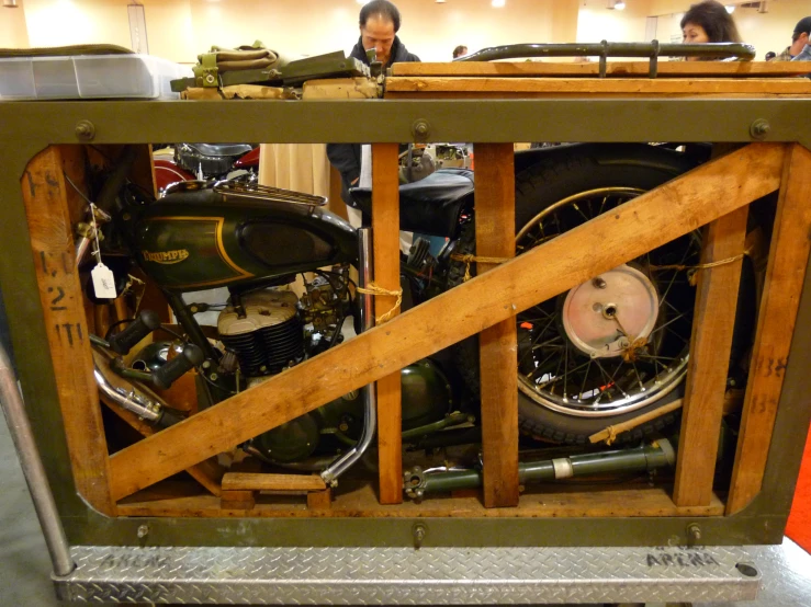 a display of motorcycles is in the room with people