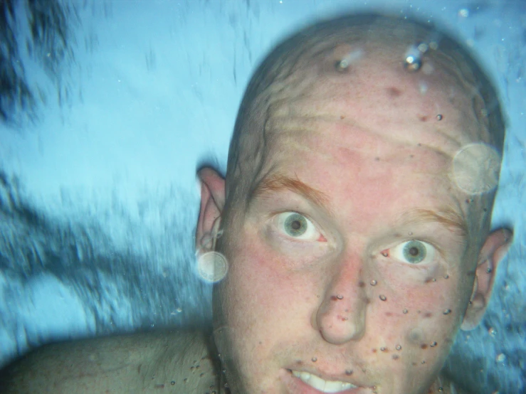 a man with bubbles surrounding his face and eyes