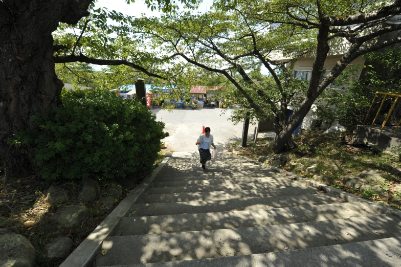 a woman is walking down a set of stairs