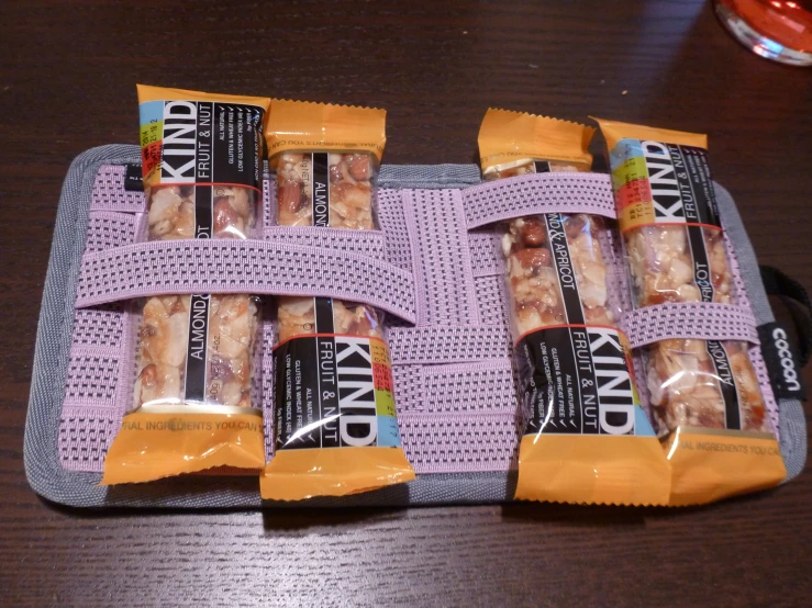 four bagged snacks sitting on a wooden table