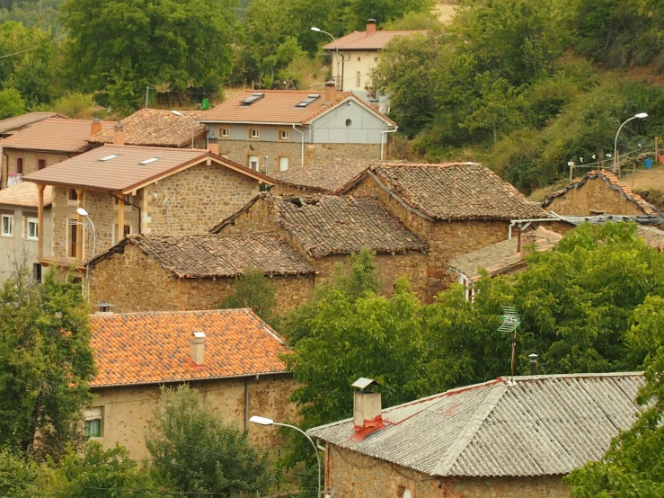 several roofs of stone houses on a hillside